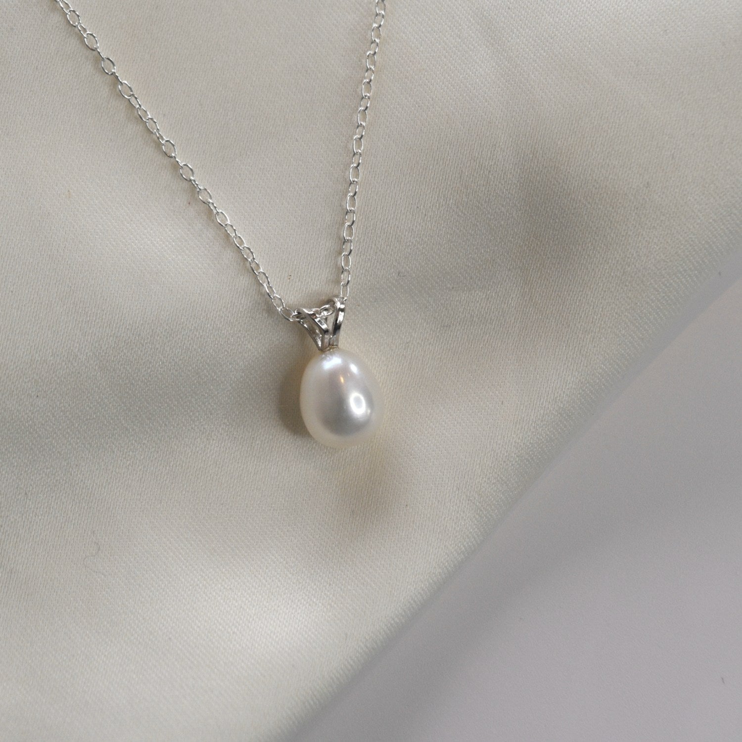White Gold Drop Pearl Necklace with a lustrous freshwater pearl pendant on a delicate sterling silver chain.