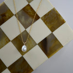 Yellow Gold Pearl Drop Necklace with a cultured freshwater pearl pendant on a delicate gold chain.