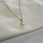 Yellow Gold Pearl Drop Necklace with a cultured freshwater pearl pendant on a delicate gold chain.