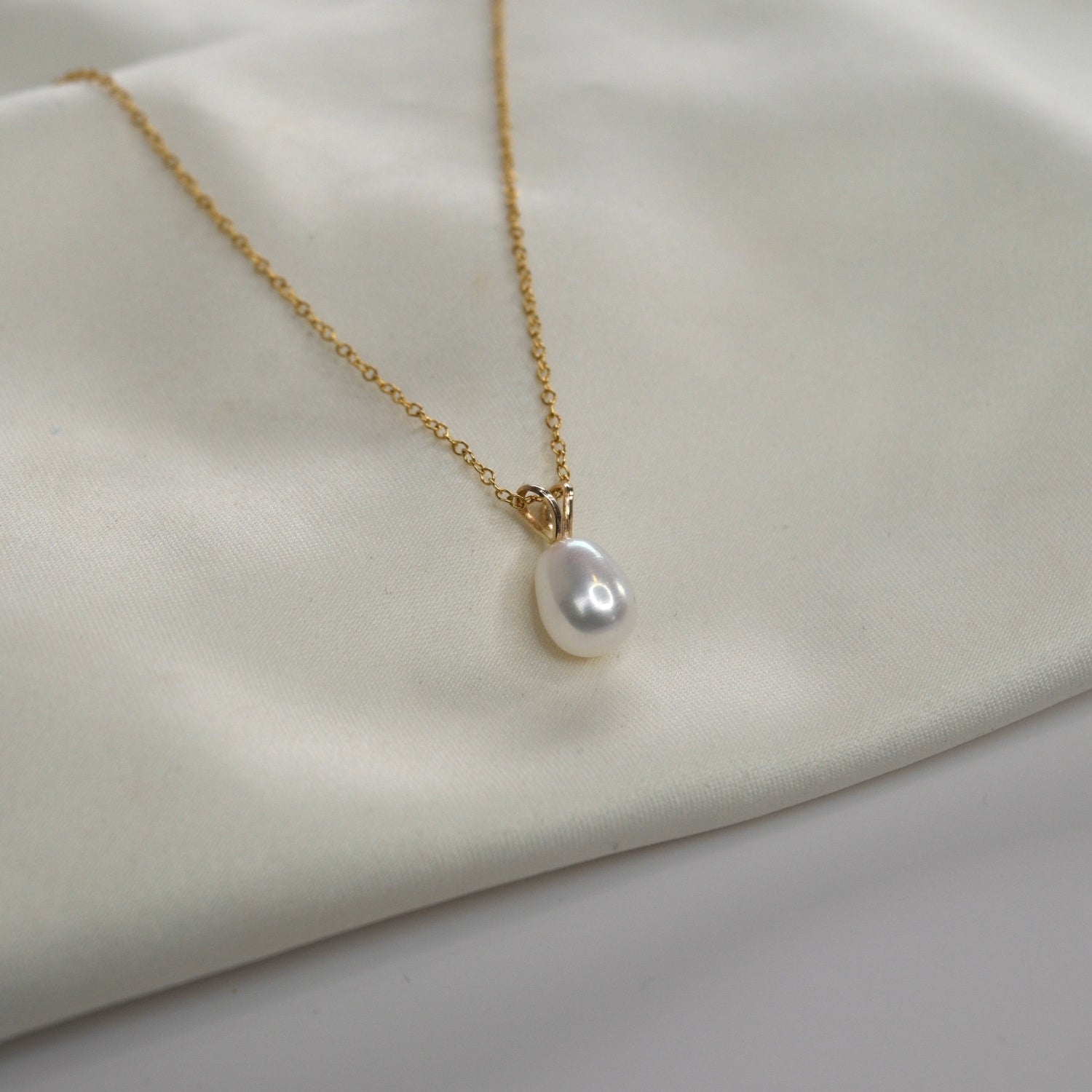 Yellow Gold Pearl Drop Necklace with a cultured freshwater pearl pendant on a delicate gold chain.